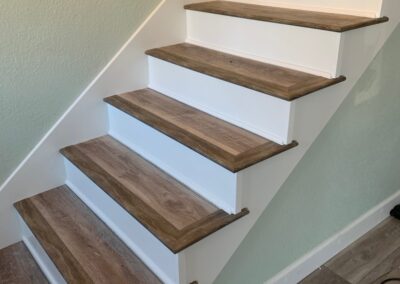 Luxury vinyl plank steps with painted risers in Folsom.